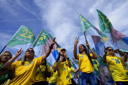 Supporters dance during a campaign event for incumbent President Jair Bolsonaro, in Brasilia, Brazil, Saturday, Oct. 29, 2022.  Bolsonaro is facing former President Luiz Inacio Lula da Silva in a runoff election set for Oct. 30. (AP Photo/Eraldo Peres)