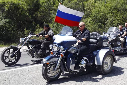 Russia's Prime Minister Vladimir Putin, foreground, rides a Harley-Davidson Lehman Trike as he arrives for the meeting with Russian and Ukrainian bikers at their camp near Sevastopol, in Ukraine's Crimea Peninsula, on July 24, 2010.  Harley-Davidson halted motorcycle shipments to Russia and said its thoughts “continue for the safety of the people of Ukraine.”. (Sergei Karpukhin/Pool Photo via AP, File)