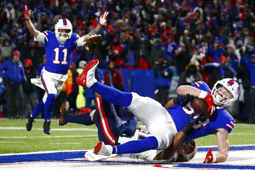 Buffalo Bills tight end Dawson Knox (88) makes a catch for a touchdown during the first half of an NFL wild-card playoff football game against the New England Patriots in Orchard Park, N.Y., Saturday, Jan. 15, 2022. The Bills signed tight end Dawson Knox to a four-year contract extension in a move made on Wednesday, Sept. 7, 2022, that locks up one of the team's top scoring threats.(AP Photo/ Jeffrey T. Barnes, File)