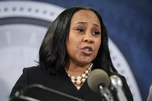 Fulton County District Attorney Fani Willis speaks during a news conference, Aug. 14, 2023, in Atlanta. People connected with former President Donald Trump’s legal cases have been inundated with threats. In Atlanta, Willis, who brought criminal charges against Trump and 18 other people alleging they schemed to illegally overturn the 2020 election results in Georgia, is known to be accompanied by round-the-clock bodyguards. (AP Photo/John Bazemore, File)