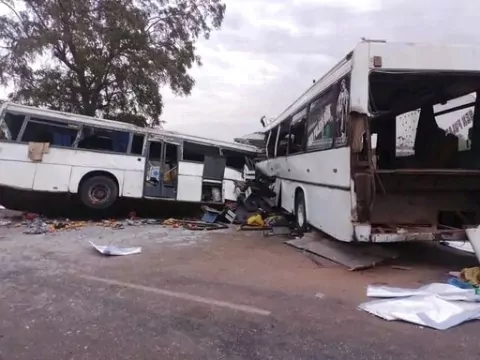 Two damaged buses are pictured after they collided on a road in Gniby, Senegal, Sunday Jan. 8, 2023. At least 40 people were killed and dozens injured in this bus crash in central Senegal, the country's president Macky Sall said Sunday. (Elimane Fall via AP)