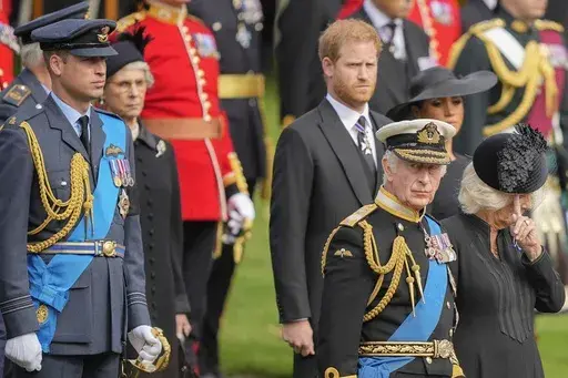 King Charles III, front right, Camilla, the Queen Consort, Prince Harry and Prince William watch as the coffin of Queen Elizabeth II is placed into the hearse following the state funeral service in Westminster Abbey in central London Monday Sept. 19, 2022. King Charles III has been diagnosed with a form of cancer and has begun treatment, Buckingham Palace says on Monday, Feb. 5, 2024. (AP Photo/Martin Meissner, Pool, File)