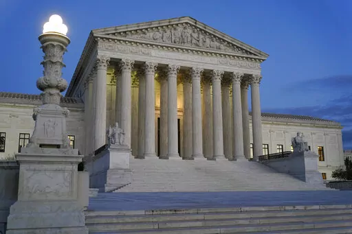 Light illuminates part of the Supreme Court building at dusk on Capitol Hill in Washington, Nov. 16, 2022. In courtrooms across America, defendants get additional prison time for crimes that juries found they didn’t commit. The Supreme Court is being asked, again, to put an end to the practice.(AP Photo/Patrick Semansky, File)