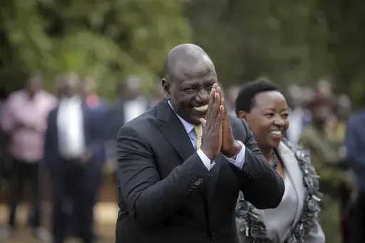 Kenya's President William Ruto gestures to party officials as he walks with his wife Rachel Ruto as he prepares to address the media at his official residence in Nairobi, Kenya Monday, Sept. 5, 2022. The ballooning debt in East Africa's economic hub of Kenya is expected to grow even more after deadly protests forced the rejection of a finance bill that President William Ruto said was needed to raise revenue. He now warns “it will have huge consequences.” (AP Photo/Brian Inganga, File)
