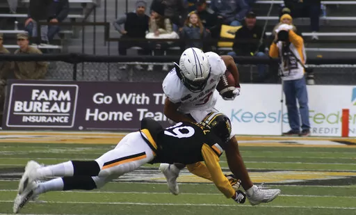 South Alabama Receiver Devin Voisin tries to break the tackle from Southern Miss Safety Camron Harrell in the first half of an NCAA college football game on Saturday, Nov. 19, 2022, in Hattiesburg, Miss. (Aimee Cronan/The Gazebo Gazette via AP)