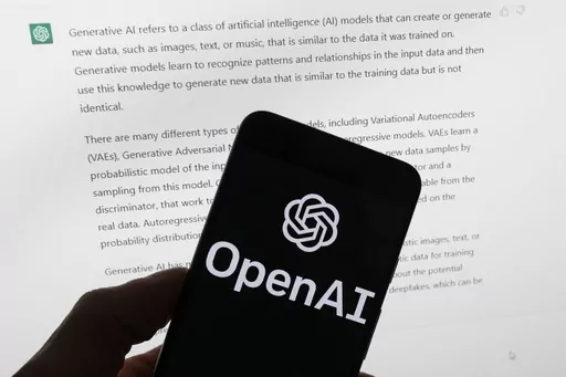 The OpenAI logo is seen on a mobile phone in front of a computer screen displaying output from ChatGPT, March 21, 2023, in Boston. As state lawmakers rush to get a handle on fast-evolving artificial intelligence technology, they're often focusing first on their own state governments before imposing restrictions on the private sector. Legislators are seeking ways to protect constituents from discrimination and other harms while not hindering cutting-edge advancements in medicine, science, busines