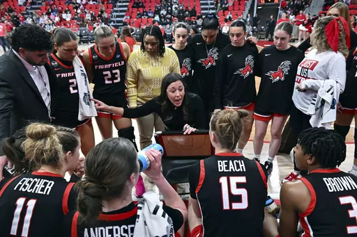 Fairfield coach Carly Thibault, center, speaks with her team during a timeout in an NCAA college basketball game, Feb. 8, 2024, in Fairfield, Conn. No. 25 Fairfield earned its first-ever ranking last week and became the eighth team to run through conference play undefeated. The Stags have a 26-game winning streak and their lone loss came to Vanderbilt, which is on the NCAA bubble. If Fairfield makes it to the final of the tournament on Saturday, March 16, 2024, and loses they might still have a 