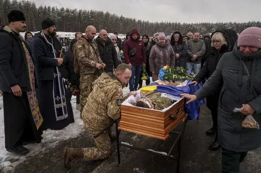 During a funeral ceremony in Irpin, the Kyiv region of Ukraine, on Nov. 21, serviceman Roman bids farewell to a comrade from the 47th Brigade -- Serhii Solovyov -- who was killed during fighting with Russian Forces in Kursk on November 12, 2024. (AP Photo/Evgeniy Maloletka, File)