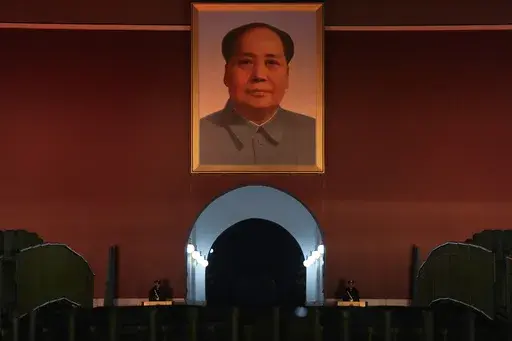 Chinese paramilitary policemen stand guard below a giant portrait of late Chinese leader Mao Zedong hung on Tiananmen Gate in Beijing, China, Wednesday, July 5, 2025. (AP Photo/Ng Han Guan)