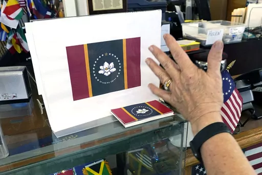 Mississippi Gov. Tate Reeves announced on Tuesday, May 2, 2023, that the state is getting a new standard license plate in January 2024 that features the magnolia also seen on the state flag. The flag is shown at A Complete Flag Source in Jackson, Miss., Oct. 27, 2020. (AP Photo/Rogelio V. Solis, File)