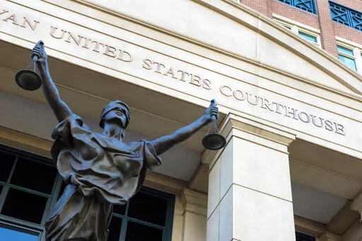The U.S. Courthouse is seen in Alexandria, Va., Thursday, Sept. 2, 2021.   A woman who once lived in Kansas has been arrested after federal prosecutors charged her with joining the Islamic State group and leading an all-female battalion of AK-47 wielding militants. The U.S. Attorney in Alexandria, announced Saturday, Jan. 29, 2022, that 42-year-old Allison Fluke-Ekren has been charged with providing material support to a terrorist organization.  (AP Photo/Cliff Owen, File)