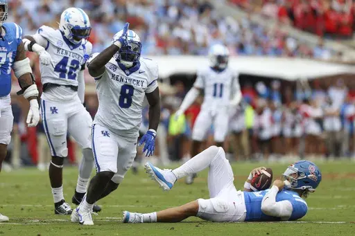 Kentucky defensive lineman Octavious Oxendine (8) reacts after sacking Mississippi quarterback Jaxson Dart (2) during the first half of an NCAA college football game against Mississippi Saturday, Sept. 28, 2024, in Oxford, Miss. (AP Photo/Randy J. Williams)