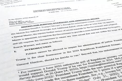 A court filing by lawyers for former President Donald Trump is photographed Monday, Aug. 22, 2022, as lawyers ask a federal judge to prevent the FBI from continuing to review documents recovered from his Florida estate until a neutral special master can be appointed. The attorneys asserted in a court filing, their first since the FBI search of Mar-a-Lago two weeks ago, that the sets of documents taken from the residence were "presumptively" covered by executive privilege. (AP Photo/Jon Elswick)