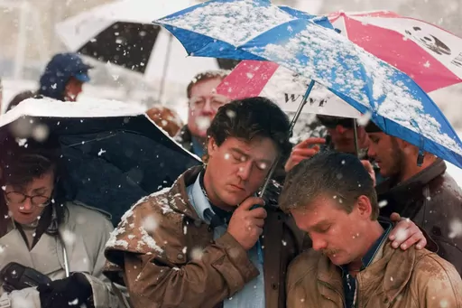 Brian Harrington, right, and Chuck Beauchine pray with other mourners during the funeral of Matthew Shepard at St. Mark's Episcopal Church Friday, Oct. 16, 1998, in Casper, Wyo. Shepard, an openly gay University of Wyoming student, died Monday from a beating in Laramie, Wyoming that's widely considered to have been at least in part motivated by his sexual orientation. (AP Photo/Michael S. Green, File)