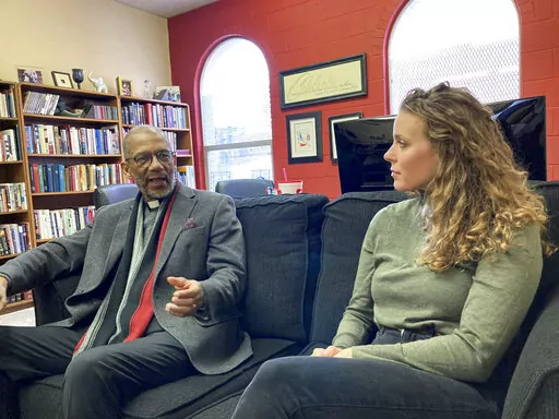 The Rev. Darryl Gray, left, and the Rev. Lauren Bennett speak in Bennett's office in St. Louis, Mo., on Jan. 10, 2023. Both served as spiritual advisers at recent executions in Missouri, sitting alongside the inmates and touching them as the process occurred. Spiritual advisers have been increasingly present during executions since a Supreme Court ruling last year. (AP Photo/Jim Salter