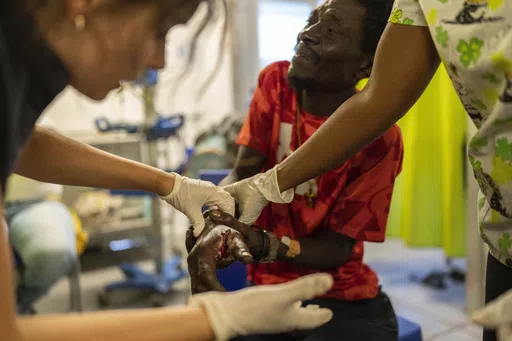 Marc Baptiste is treated for a bullet wound at a Doctors Without Borders emergency room in the Cite Soleil neighborhood of Port-au-Prince, Haiti, Friday, April 19, 2024. Baptiste said police in an armored vehicle shot him the previous day as he was collecting wood to sell as kindling in an area controlled by gangs. Haiti's health system has long been fragile, but it's now nearing total collapse after gangs launched coordinated attacks on Feb. 29, targeting critical state infrastructure in the ca