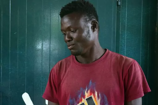 Sahr John Yambasu, 29, from Sierra Leone, poses for a photograph in Niamey, Niger, Tuesday, Aug. 22, 2023. After three months of traipsing through the desert and watching people die at sea trying to reach Europe, Yambasu decided to return home. But when he reached Niger in June on his journey back, United Nations officials told him to wait until the packed migrant centers emptied before he could be repatriated. Then weeks later mutinous soldiers toppled Niger's president shuttering the borders a