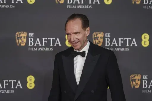 Ralph Fiennes poses for photographers upon arrival at the 78th British Academy Film Awards, BAFTA's, in London, Sunday, Feb. 16, 2025. (Photo by Joel C Ryan/Invision/AP)