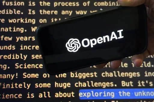 The OpenAI logo appears on a mobile phone in front of a screen showing part of the company website in this photo taken on Nov. 21, 2023 in New York. Negotiators will meet this week to hammer out details of European Union artificial intelligence rules but the process has been bogged down by a simmering last-minute battle over how to govern systems that underpin general purpose AI services like OpenAI's ChatGPT and Google's Bard chatbot. (AP Photo/Peter Morgan, File)