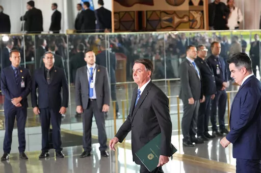 Brazilian President Jair Bolsonaro arrives to speak from his official residence of Alvorada Palace in Brasilia, Brazil, Nov. 1, 2022, the leader's first public comments since losing the Oct. 30 presidential runoff. Bolsonaro has dropped out of public view and has not disavowed the recent emergence of violence by his supporters who refuse to accept his narrow defeat. (AP Photo/Eraldo Peres, File)