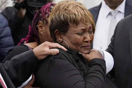 Bettersten Wade, mother of Dexter Wade, who died after being hit by a Jackson, Miss., police SUV driven by an off-duty officer, cries after her son's body is exhumed from a pauper's cemetery in Raymond, Miss., Nov. 13, 2023. A judge on Friday, May 31, 2024, ordered the enforcement of a lawsuit settlement between the city of Jackson and the family of 62-year-old George Robinson, who died after police officers pulled him from a car while searching for a murder suspect in 2019. Wade is Robinson's s