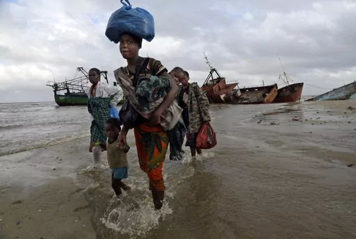 FILE — Displaced families arrive after being rescued by boat from a flooded area of Buzi district, 200 kilometers (120 miles) outside Beira, Mozambique, Saturday, March 23, 2019. Much of the world takes daily weather forecasts for granted. But most of Africa's 1.3 billion people live with little advance knowledge of what's to come. That can be deadly, with damage running in the billions of dollars. The first Africa Climate Summit opens this week in Kenya to highlight the continent that will su