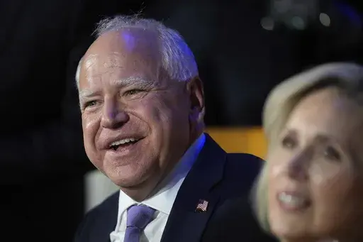 Democratic vice presidential nominee Minnesota Gov. Tim Walz and his wife Gwen Walz watch during the Democratic National Convention Monday, Aug. 19, 2024, in Chicago. (AP Photo/Erin Hooley)
