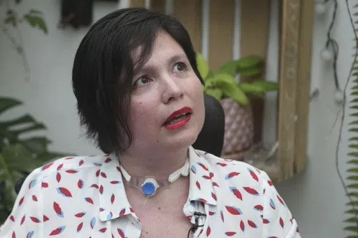 Ana Estrada, a Peruvian psychologist who is almost completely paralyzed by a terminal illness, gives an interview at her home in Lima, Peru, Dec. 18, 2019. Estrada, who was authorized in 2022 by Peru's Supreme Court to receive euthanasia, has died, her lawyer said Monday, April 22, 2024. (AP Photo/Martin Mejia, File)