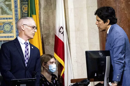 Los Angeles City Councilman Kevin de León, right, speaks with City Council President Pro Tem Mitch O'Farrell before leaving a council meeting on Tuesday, Oct. 11, 2022 in Los Angeles. (Sarah Reingewirtz/The Orange County Register via AP)