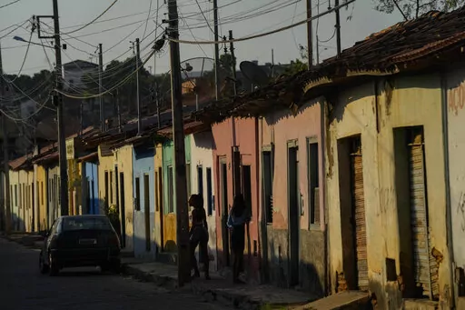 Residents stand on the sidewalk in Aracuai, Brazil, Oct. 11, 2022. Araçuai is part of the Jequitinhonha Valley in northern Minas Gerais state, bordering the poor northeast region that is a stronghold for former President Luiz Inacio Lula da Silva, who is running for president again. Gaining traction in Minas Gerais is especially important to incumbent Jair Bolsonaro, as the state has the second-largest population in the country. The two presidential candidates will face each other in a runoff O