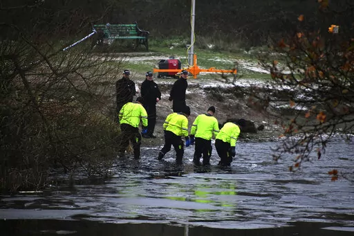 Police search teams at the scene after children fell through ice,in Babbs Mill Park in Kingshurst, Solihull, England, Monday, Dec. 12, 2022. Three young boys who fell through ice covering a lake in central England have died and a fourth remains hospitalized as weather forecasters issued severe weather warnings for large parts of the United Kingdom. Rescuers pulled the boys, aged 8, 10 and 11, from the icy waters Sunday afternoon and rushed them to the hospital in the West Midlands, about 100 mil
