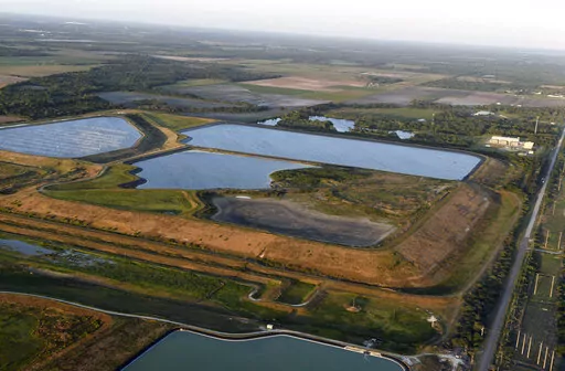 This aerial photo taken from an airplane shows a reservoir near the old Piney Point phosphate mine on April 3, 2021, in Bradenton, Fla. The polluted leftovers of Florida's phosphate fertilizer mining industry, more than 1 billion tons in “stacks” that resemble enormous ponds, are at risk for leaks or other contamination triggered by Hurricane Ian, said environmental groups Tuesday, Sept. 27, 2022. (Tiffany Tompkins/The Bradenton Herald via AP, File)