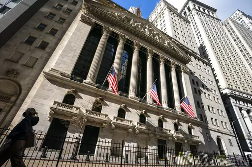A pedestrian walks past the New York Stock Exchange, Monday, Jan. 24, 2022, in New York.  Stocks are falling in early trading on Wall Street Friday, April 29, putting major indexes back into the red for the week after several sharp moves both up and down.  (AP Photo/John Minchillo, File)