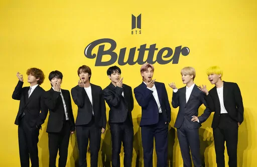 FILE- Members of South Korean K-pop band BTS, V, SUGA, JIN, Jung Kook, RM, Jimin, and j-hope from left to right, pose for photographers ahead of a press conference to introduce their new single "Butter" in Seoul, South Korea, May 21, 2021. The members of K-pop band BTS will serve their mandatory military duties under South Korean law, their management company said Monday, Oct. 17, 2022, effectively ending a debate on exempting them because of their artistic accomplishments. (AP Photo/Lee Jin-man