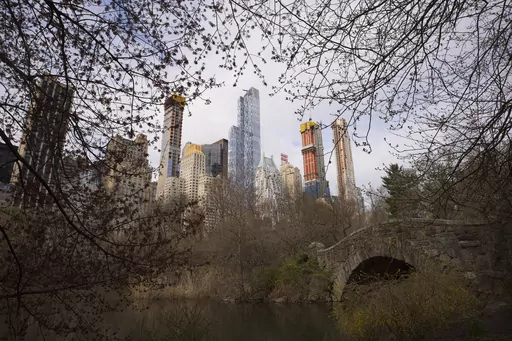 Skyscrapers overlook Central Park and Gapstow Bridge, April 17, 2018, in New York. According to officials, a man stabbed a pit bull to death following a quarrel with the dog's owner in New York City's Central Park. The seriously injured dog was transported to a local animal clinic, where he was euthanized after the stabbing Saturday evening, June 17, 2023, police said. (AP Photo/Mark Lennihan, File)