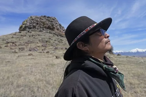 Gary McKinney, a spokesman for People of Red Mountain and a member of the nearby Duck Valley Shoshone-Paiute Tribe, walks near Sentinel Rock on April 25, 2023, outside of Orovada, Nev. The Reno-Sparks Indian Colony is abandoning its 3-year lawsuit aimed at blocking a lithium mine currently under construction at Thacker Pass in northwest Nevada. Tribal leaders say the U.S. Interior Department refuses to accept their arguments that the mine's on a sacred site where more than two dozen Paiute and S