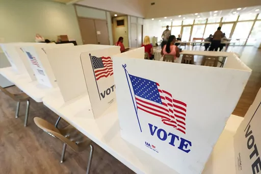 Empty poll kiosks await voters at the Mississippi Second Congressional District Primary election precinct June 7, 2022, in Jackson, Miss. Prosecutors are trying to stop the menacing of election workers as violent and graphic threats are deluging workers even in normally quiet periods between elections. (AP Photo/Rogelio V. Solis, File)