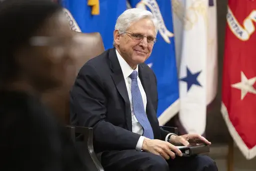 Attorney General Merrick Garland sits during a farewell ceremony at the Department of Justice, Thursday, Jan. 16, 2025, in Washington. (AP Photo/Mark Schiefelbein)