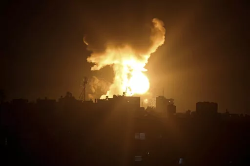 An explosion caused by Israeli airstrikes is seen in the town of Khan Younis, southern Gaza Strip, Sunday Jan, 2, 2022. Israel’s military says it launched strikes against militant targets in the Gaza Strip, a day after rockets were fired from the Hamas-ruled territory. (AP Photo/Yousef Masoud)