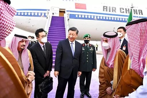 Chinese President Xi Jinping, center, greets by Prince Faisal bin Bandar bin Abdulaziz, Governor of Riyadh, after his arrival in Riyadh, Saudi Arabia, Wednesday, Dec. 7, 2022. (Saudi Press Agency via AP)