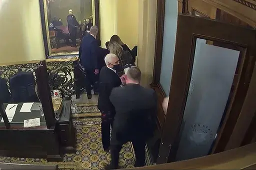 In this image from video, a security video shows Vice President Mike Pence being evacuated from near the Senate chamber as rioters breach the Capitol, on Jan. 6, 2021, at the Capitol in Washington. (Senate Television via AP)