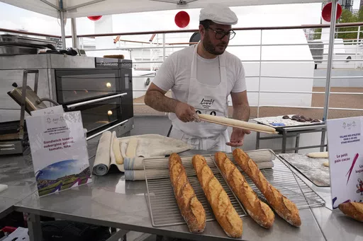 French baker Tony Dore prepares baguettes, like those that will be served during the. Olympic Games, Tuesday, April 30, 2024 in Paris. Some 40,000 meals will be served each day during the Games to over 15,000 athletes housed at the Olympic village. (AP Photo/Michel Euler)