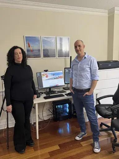 Michal Harel and her husband Avital Epstein show the website they set up to help Israelis navigate a move to Canada in Oakville, Ontario, Canada, Wednesday, Dec. 4, 2024. (AP Photo/Rob Gillies)