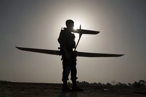 An Israeli soldier prepares a drone to be launched near the Israeli-Gaza border, southern Israel, Tuesday, Jan. 9, 2024. (AP Photo/Leo Correa)