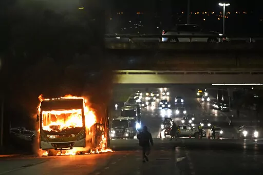 Supporters of Brazilian President Jair Bolsonaro clash with police setting fire to several vehicles and allegedly trying to storm the headquarters of the Federal Police in Brasilia, Brazil, Monday, Dec. 12, 2022. Since Bolsonaro lost re-election to Luiz Inácio Lula da Silva on Oct. 30, his supporters have gathered across the country refusing to concede defeat and asking for the armed forces to intervene. (AP Photo/Eraldo Peres)
