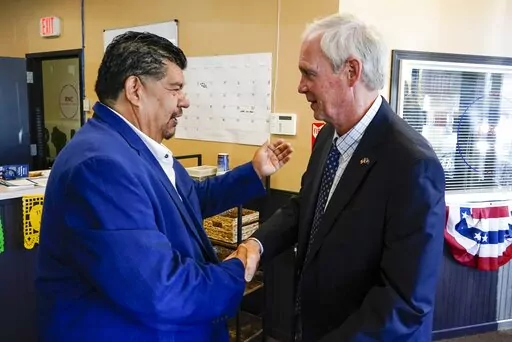 Wisconsin Republican U.S. Senate candidate Ron Johnson and Pastor Marty Calderon shake hands at a local Republican election office in Milwaukee, on Saturday, Oct. 8, 2022. In two decades of street outreach on Milwaukee’s south side, Calderon has offered Bible study, gang prevention, a safe place to stay for those battling addiction, and help getting jobs for those newly released from prison. But as he’s watched rising crime threaten those efforts to “clean up” his impoverished neighborho