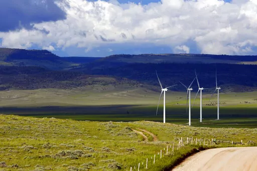 Clouds cast shadows near wind turbines at a wind farm along the Montana-Wyoming state line on June 13, 2022. The Biden administration is proposing a new permitting program for wind energy turbines, power lines and other projects that kill bald and golden eagles. (AP Photo/Emma H. Tobin, File)
