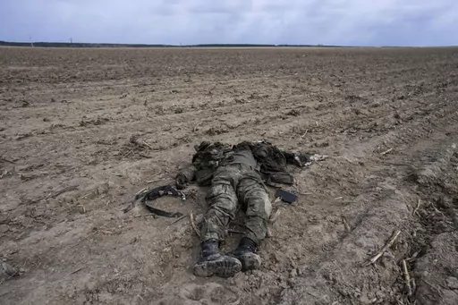 A Russian soldier killed during combats against Ukrainian army lies on a corn field in Sytnyaky, on the outskirts of Kyiv, Ukraine, Sunday, March 27, 2022. Nearly 50,000 Russian soldiers have died in the war in Ukraine, according to a new statistical analysis. (AP Photo/Rodrigo Abd, File)