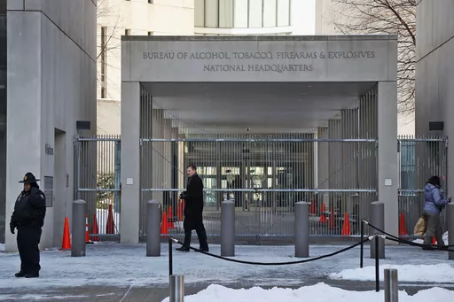 A security official walks in front of the entrance to the national headquarters of the Bureau of Alcohol, Tobacco, Firearms and Explosives on Jan. 23, 2014, in Washington. New data from the bureau shows that 68,000 illegally trafficked firearms in the U.S. came through unlicensed dealers who aren't required to perform background checks over a five year report that was released Thursday, April 4, 2024. (AP Photo/Charles Dharapak, File)